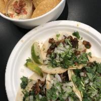 Barbacoa Taco · Topped with diced onion and cilantro. Choice of corn or flour tortilla.