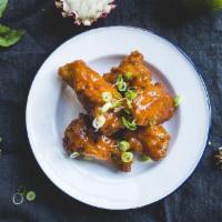 Sriracha Wings · Fried chicken wings tossed in Sriracha and sweet chili sauce. Spicy.