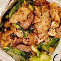 Pad Se Ew · Stir-fried flat rice noodles with choice of meat, egg, garlic, Chinese broccoli in Thai swee...