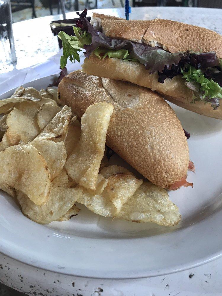 Smoked Salmon Sandwich · Smoked salmon, melted Swiss cheese and olive oil on a toasted French baguette. Served with baked potato chips.