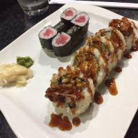 Spider Roll · Soft shell crab, regular crab, avocado, and cucumber inside with eel sauce on top.