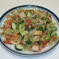 Fatoush Salad · A salad made from romaine lettuce, tomatoes, cucumber, parsley, onion, and toasted pita brea...