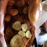 Pork Tenderloin · Extra large breaded pork cutlet, fried, and topped with pickles.