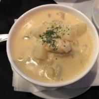 Clam Chowder · Clam chowder, creamy white, with perfect seasoning and expert use of wine.