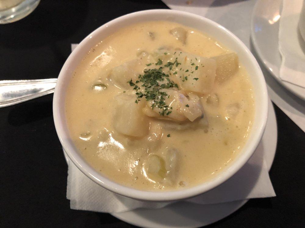 Clam Chowder · Clam chowder, creamy white, with perfect seasoning and expert use of wine.