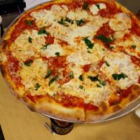 Margherita Pizza · Fresh mozzarella, crushed tomatoes, basil and olive oil.