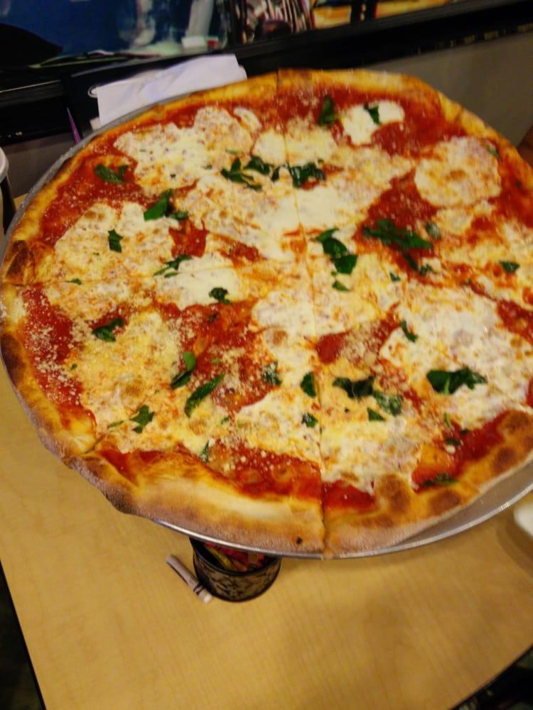 Margherita Pizza · Fresh mozzarella, crushed tomatoes, basil and olive oil.
