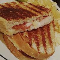 Club Panini · Oven-roasted turkey, bacon, cheddar, tomato, mayonnaise, and grilled sourdough.
