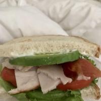 Uptown Turkey Avocado Sandwich · Oven-roasted turkey, bacon, avocado, tomato, lettuce, mayonnaise, and harvest toast.
