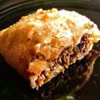 Empanada · Served with seasoned beef, raisins, olives and sweet peppers.
