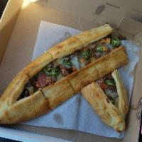 Il Forno Mixed Pide · A boat shaped dough crust stuffed with Turkish pastrami, Turkish sausage, lamb, green pepper...