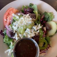 Greek Salad · Garden-fresh vegetables, Kalamata olives, and fresh romaine lettuce sprinkled with feta chee...