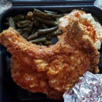 The Kings Chops · Center cut pork chop deep fried to golden perfection and served with 2 sides and a honey but...