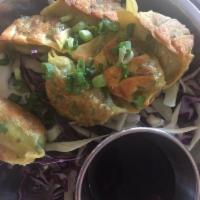 Vegetable Dumplings · 6 pieces. Carrot, bok choy, gai lan, white pepper with house soy sauce. Vegan.