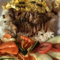 Khmer Rice Plate · Pan fried pork on a bed of white rice, also comes with fired egg, cucumbers, tomatoes and pi...