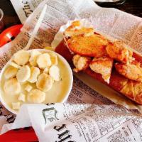 New England Clam Chowder · Hand shucked New England claim in a cream chowder, chock full of potatoes and sauteed onion.