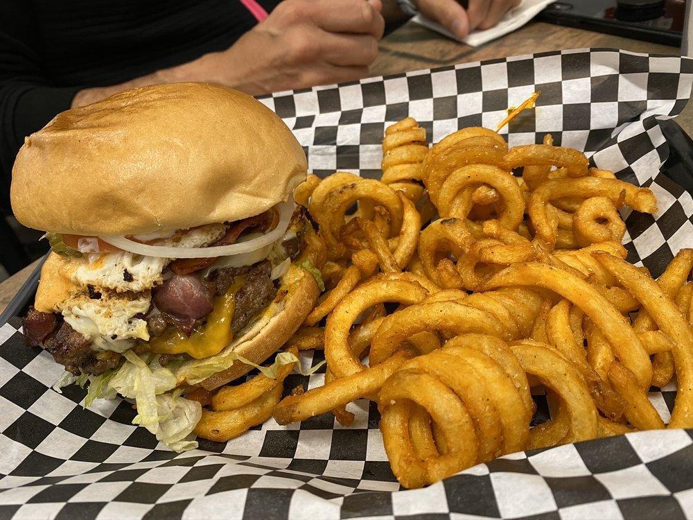 Badmash Burger · Lettuce, badmash sauce, double patty, egg, bacon Swiss or cheddar cheese, mayo, pickles, onions, and tomatoes.