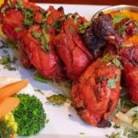 Tandoori Chicken · Bone-in chicken on onion-bed in sizzler. Baked to order in clay oven over mesquite charcoal,...