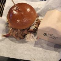 Pulled Pork Sandwich · Our slow smoked pulled pork tossed in our BBQ sauce with caramelized onions and roasted pepp...