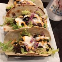 Korean Tacos · 3 warm flour tortillas filled with choice of meat on a bed of crisp lettuce, seasoned with b...