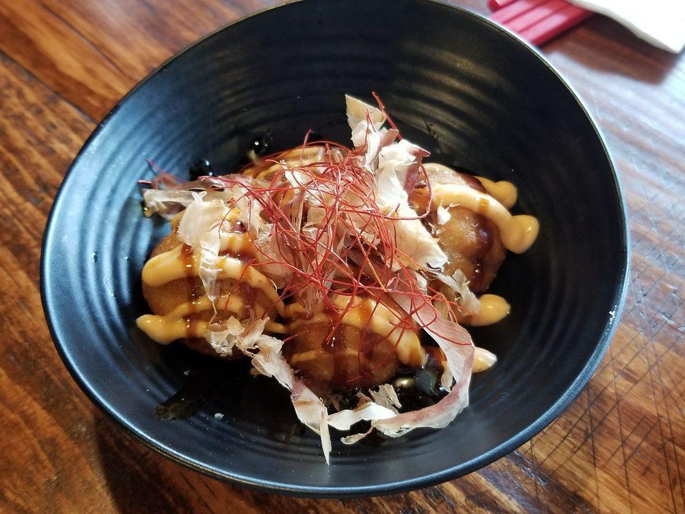 Takoyaki · Battered octopus over egg tartar topped with spicy mayo, ell sauce, scallion and bonito flakes.