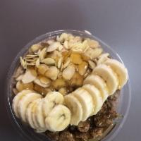 Nutty Bowl · Organic acai topped with sliced banana, natural peanut butter, granola and honey drizzle.