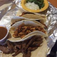 Street Tacos · 4 corn tortillas stuffed with 1 steak, 1 chicken, 1 carnitas and 1 chorizo. Served with rice...