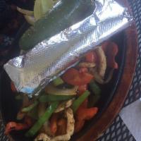 Chicken Fajitas · Grilled chicken, bell peppers, onions served with rice, beans, sour cream, pico de gallo, gu...