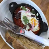 Shakshuka · Two poached eggs, zaatar, feta cheese, labneh, and grilled bread