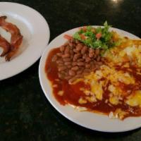 Huevos Rancheros · 2 eggs on a corn tortilla, hash browns, whole beans, choice of Frank Sr.'s red or green chil...