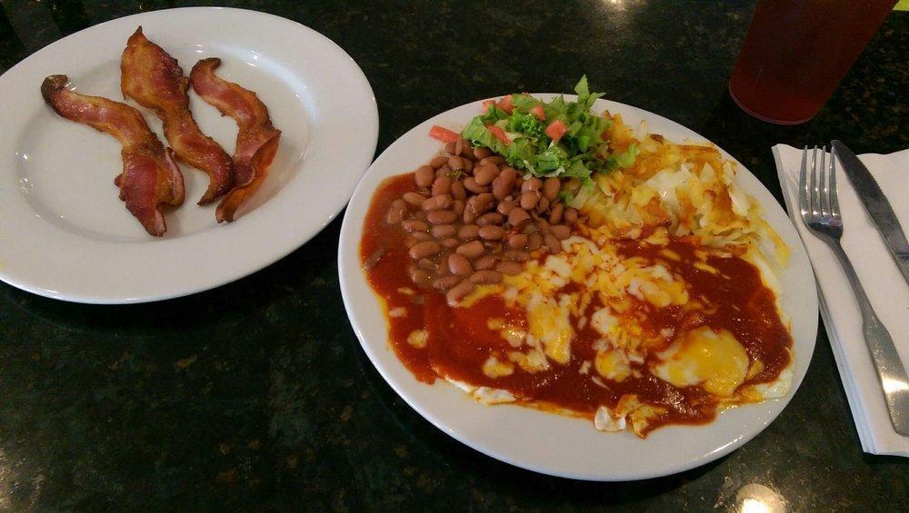 Huevos Rancheros · 2 eggs on a corn tortilla, hash browns, whole beans, choice of Frank Sr.'s red or green chile with a tortilla.