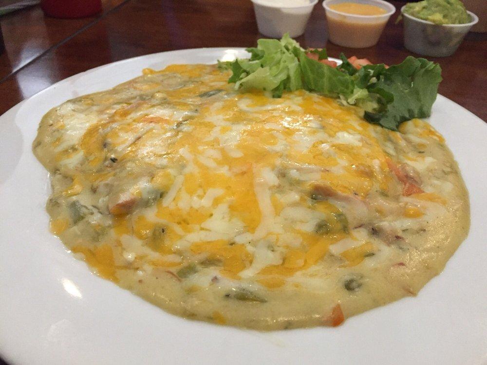 Creamy Chicken Enchilada Plate · Stuffed tortilla topped with chili sauce and creamy chicken.