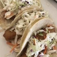 Azul Fish Tacos · Hand dipped in our signature batter and cooked to a crispy perfection, topped with azul whit...