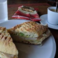Turkey Panini · Turkey/avocado/Swiss cheese/house made pesto mayo , served on ciabatta bread. Served with a ...