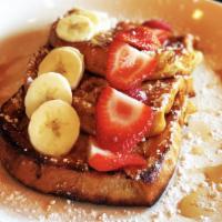 French Toast · Thick and fluffy pieces covered in fresh fruit and maple syrup.