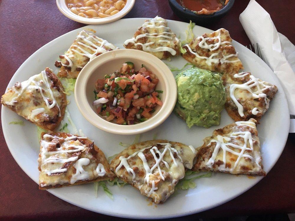 Nachos Supreme · Individually topped chips with beans, melted chihuahua cheese, your choice of meat, drizzled sour cream, with a side of pico de gallo & guacamole