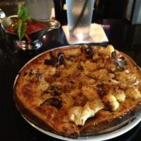 Roasted Cauliflower Pizza · Roasted cauliflower with olive oil and garlic, Romano and mozzarella cheese, topped with bre...