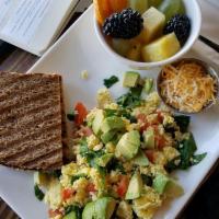 Breakfast Scramble · 2 eggs, avocado, tomatoes, spinach, and cheese served with toast.