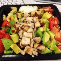 Chicken Cobb Salad · Romaine lettuce, grilled chicken, bacon, avocado, tomatoes, red onion, hard-boiled eggs, and...