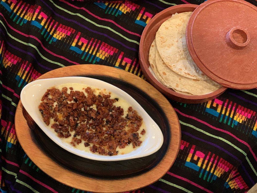 Queso Flameado · Grilled Mexican chorizo swimming in a mouthwatering melted cheese. Served with flour tortillas.