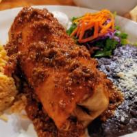 Chimichanga · Fajita chicken, steak or ground beef, served with sour cream topped with queso sauce or chil...