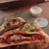 Calzone · Our fresh pizza crust filled with our homemade pizza sauce, spices, heaping mozzarella chees...