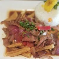 Lomo Saltado · Sirloin strips stir fried with onions, tomatoes, golden potatoes, cilantro and cumin. Served...