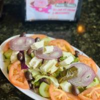 Greek Salad · Fresh lettuce, tomatoes, cucumbers, red onions, black olives and feta cheese tossed with our...