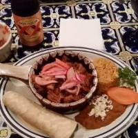Cochinita Pibil · Pulled roasted pork marinated with Annatto seeds and served with radish-habanero salsa and c...