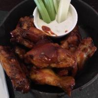 Smoked Wings · House specialty. Applewood smoked, char-grilled, tossed in choice of hot honey or bourbon Bu...