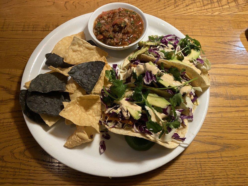 Crispy Fish Tacos · Panko-crusted filleted white fish, fresh avocado, shaved cabbage, ranchito sauce and fresh cilantro wrapped in your choice of flour-corn tortillas or lettuce cups. Served with flame-roasted salsa and our housemade blue & white corn tortilla chips.
