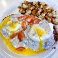 Country Eggs Benedict · Poached eggs, corned beef hash, sausage gravy and diced tomatoes on an English muffin with h...