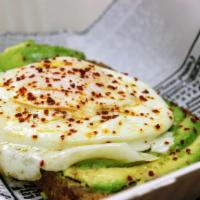 Avocado and Egg Toast · Fresh avocado on wheat toast, topped with an over easy egg and garnished with house greens a...