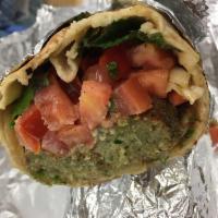 Falafel Wrap · Crispy fried falafel, diced tomatoes, cabbage salad, fresh mint, and tahini sauce. Served in...